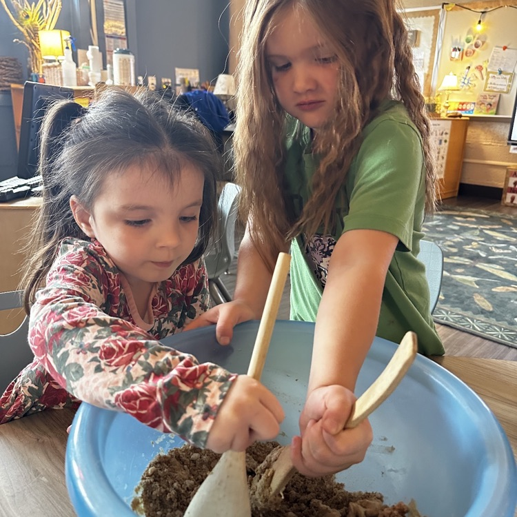 2 girls mixing batter