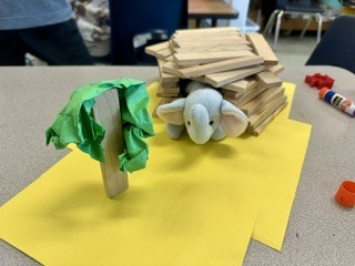 stuffed elephant in a wooden stick house