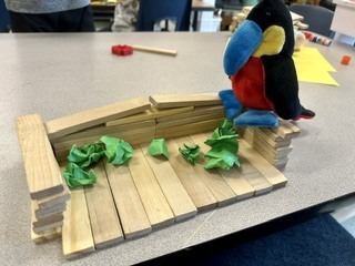 stuffed bird in a wooden stick house