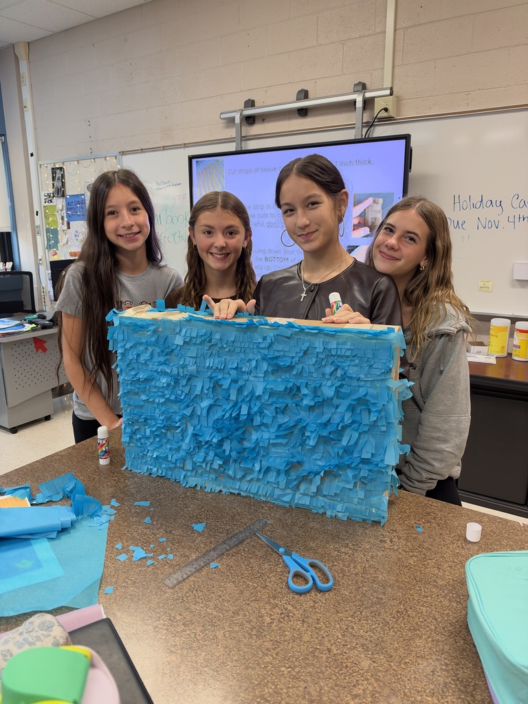 4 girls standing in front of a home made pinata