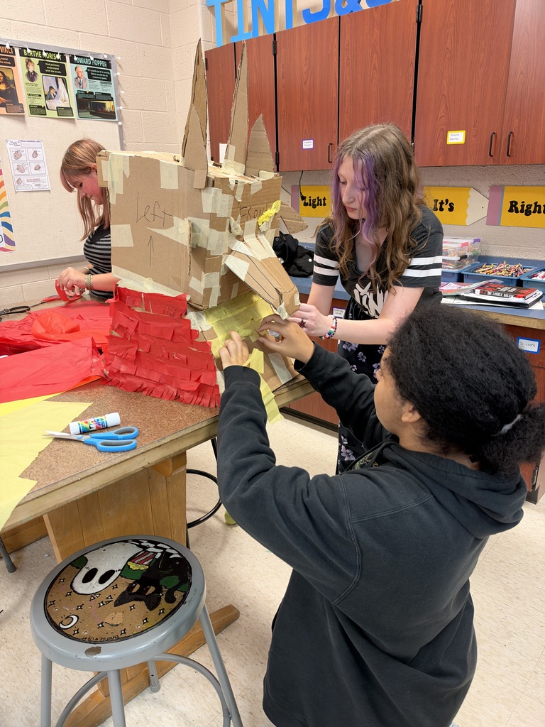 middle school students in art class making pinatas