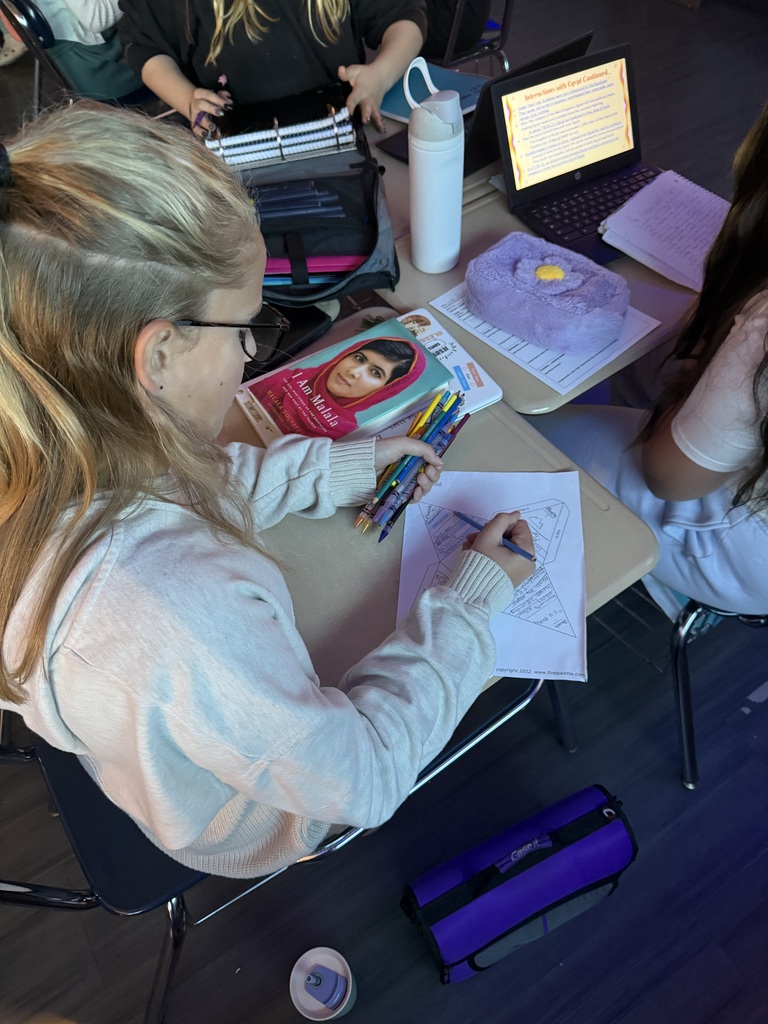girl coloring at a desk