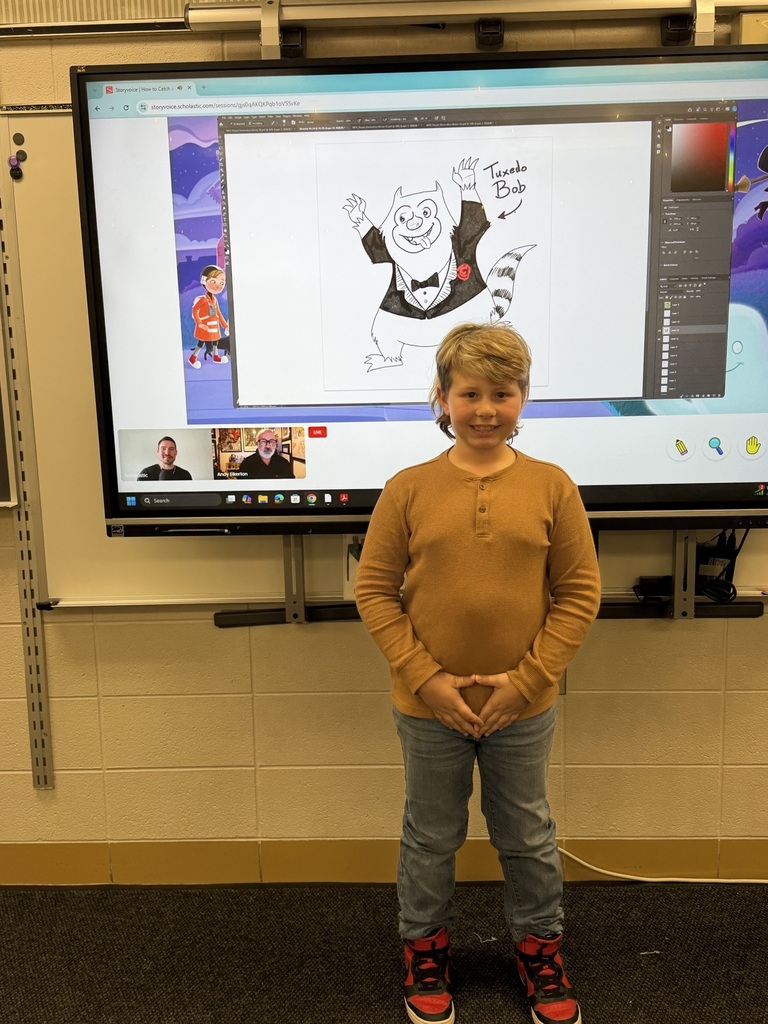 boy standing in front of a smartboard