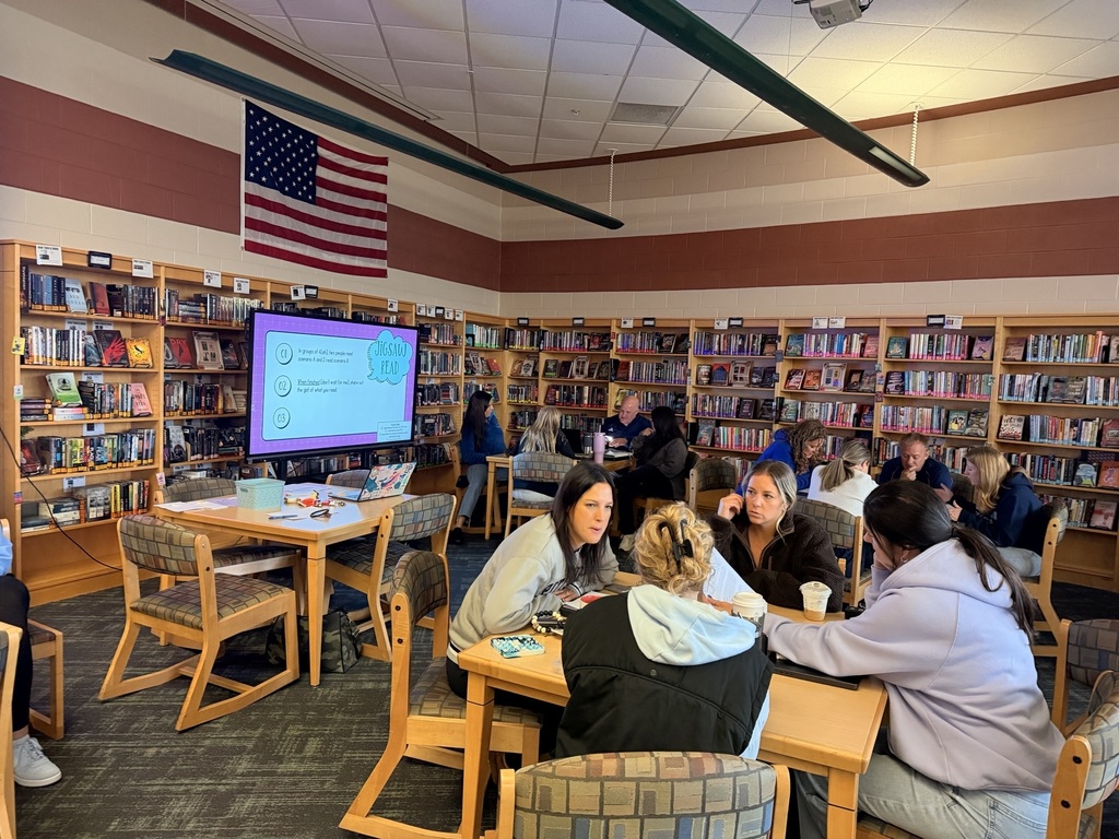adults working together at tables in a library