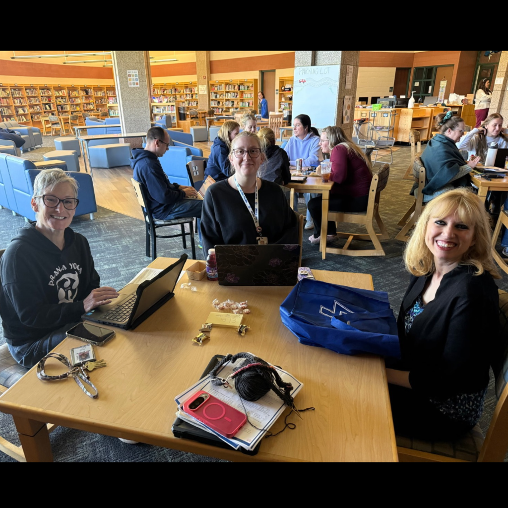 adults working together at tables in a library