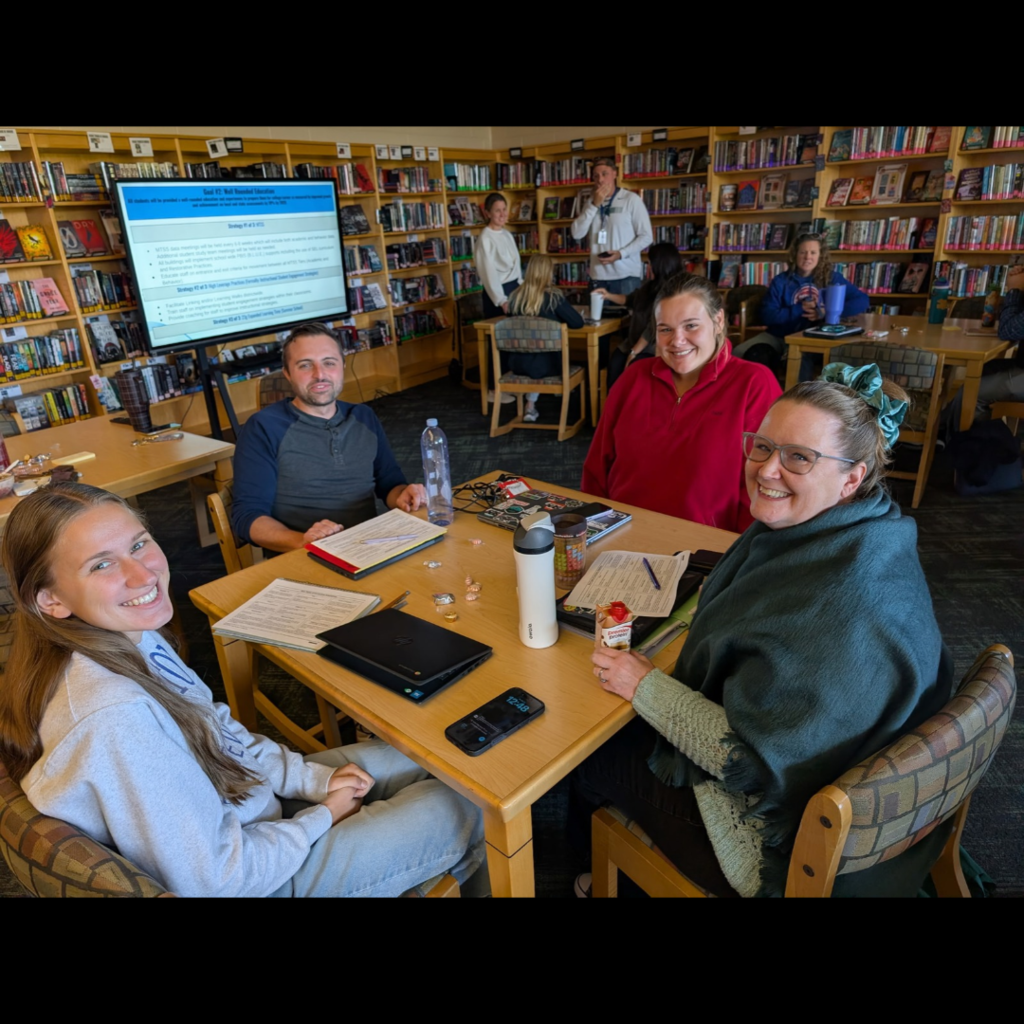 adults working together at tables in a library