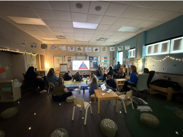 group of teachers in a circle in a classroom