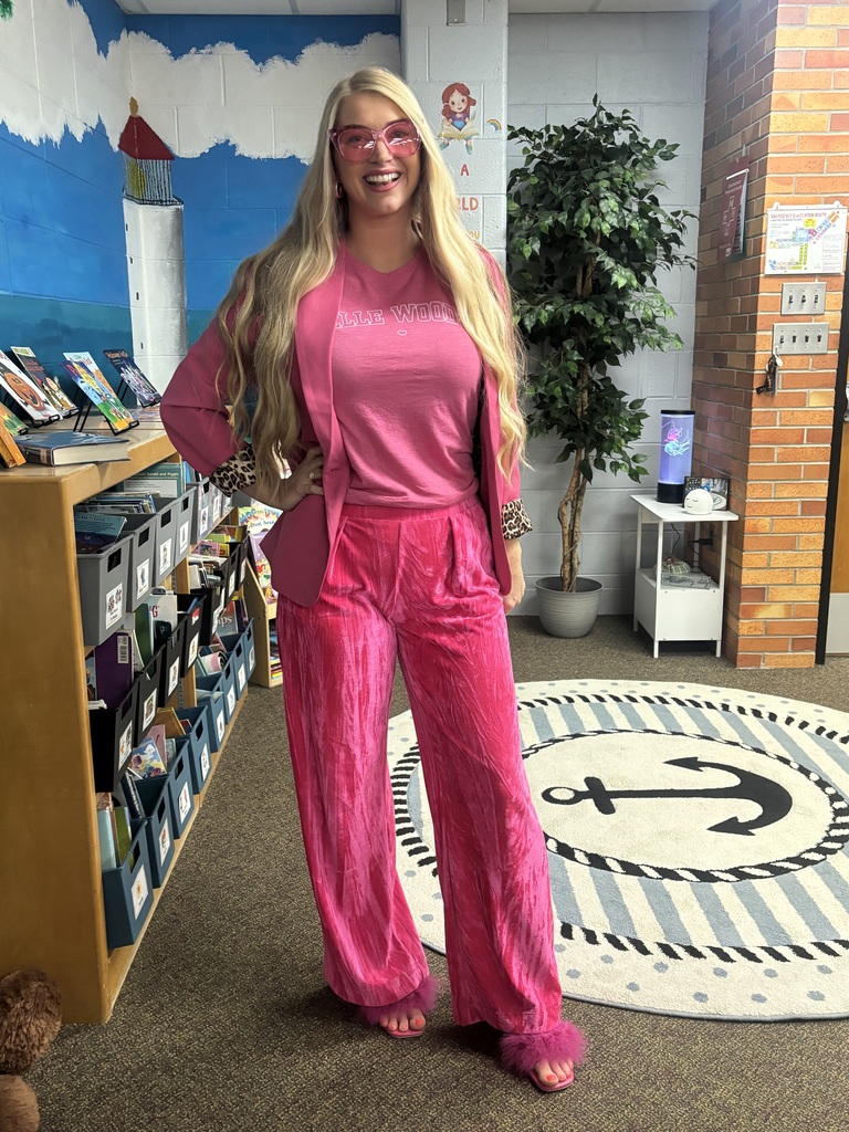 blonde woman posing dressed in all pink
