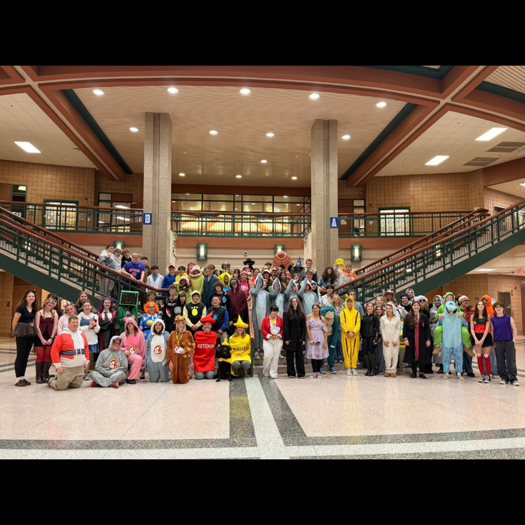 group of people in a high school posing in halloween costumes