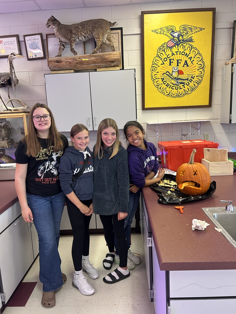 Students with carved pumpkins