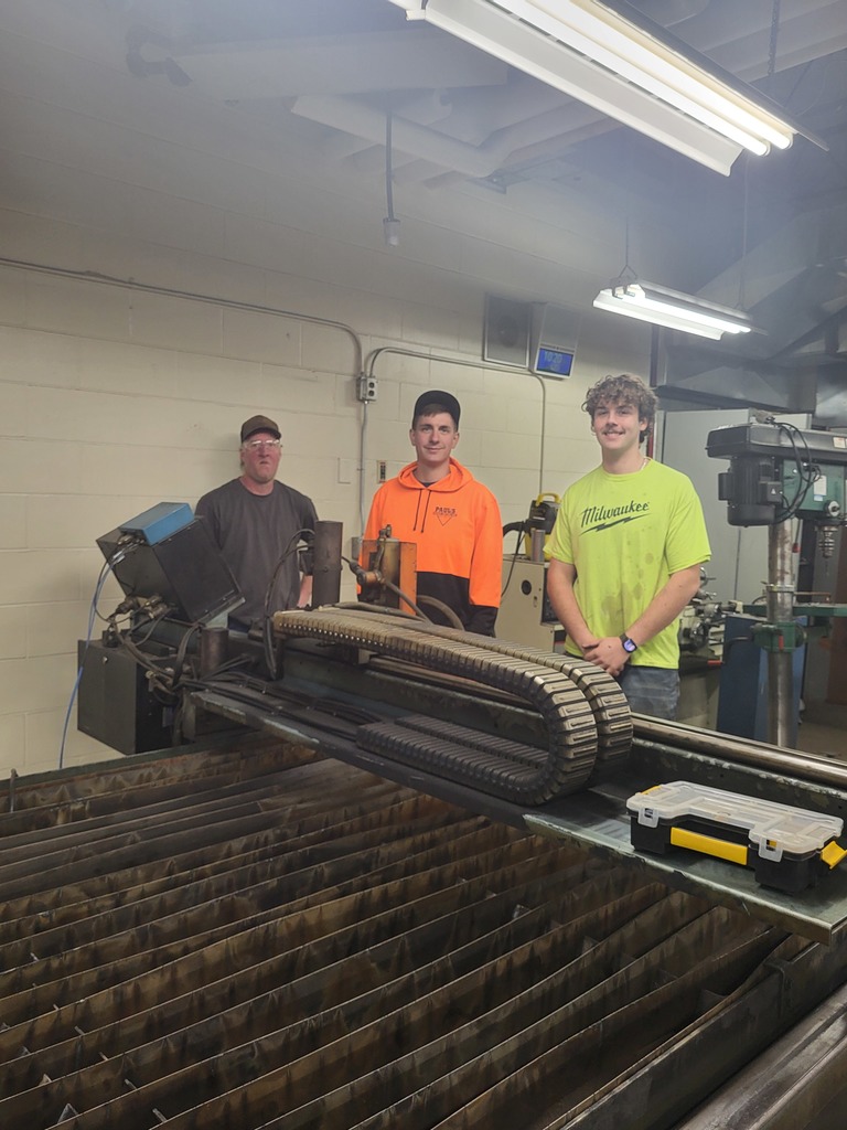 people standing before plasma cutter