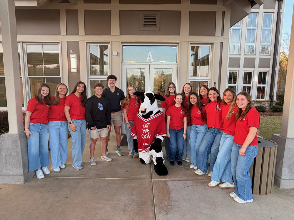group of students with CFA cow