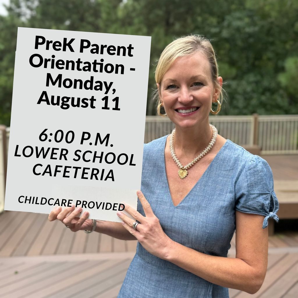 Teacher holding sign