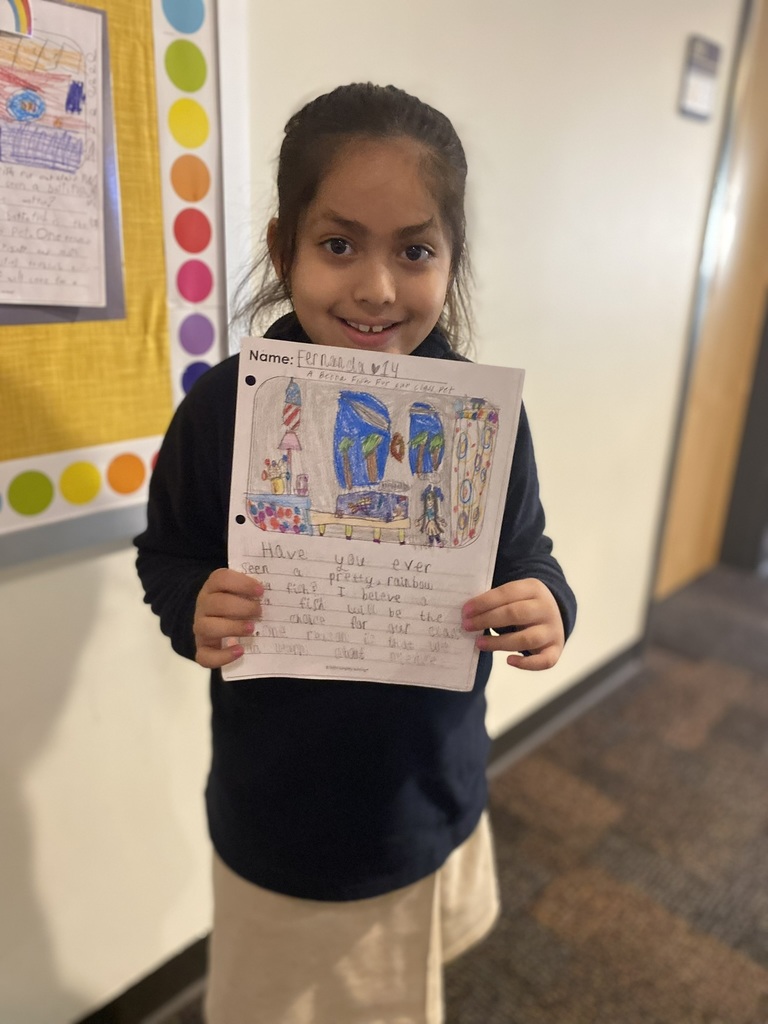 student holding up work