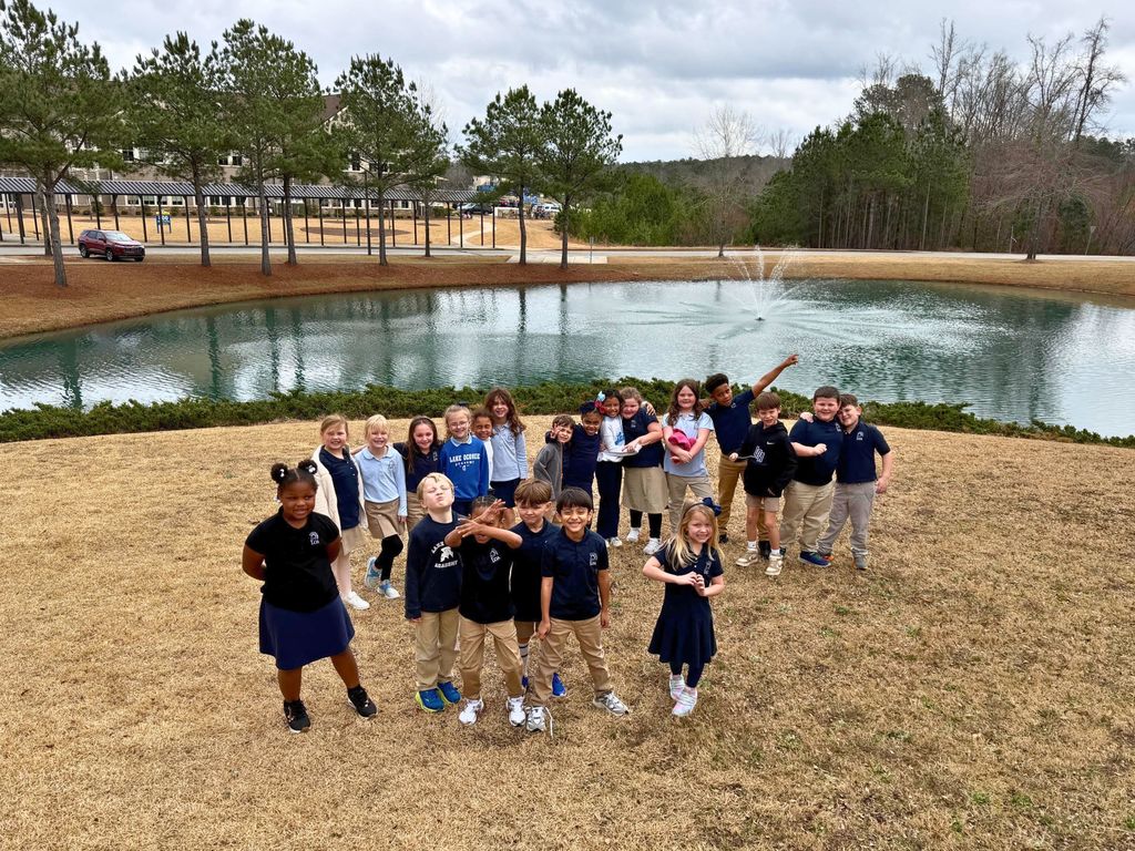 class in front of pond
