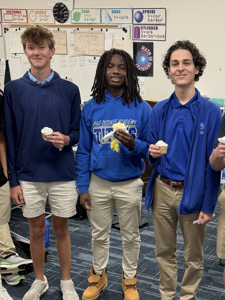 three students standing togeahter