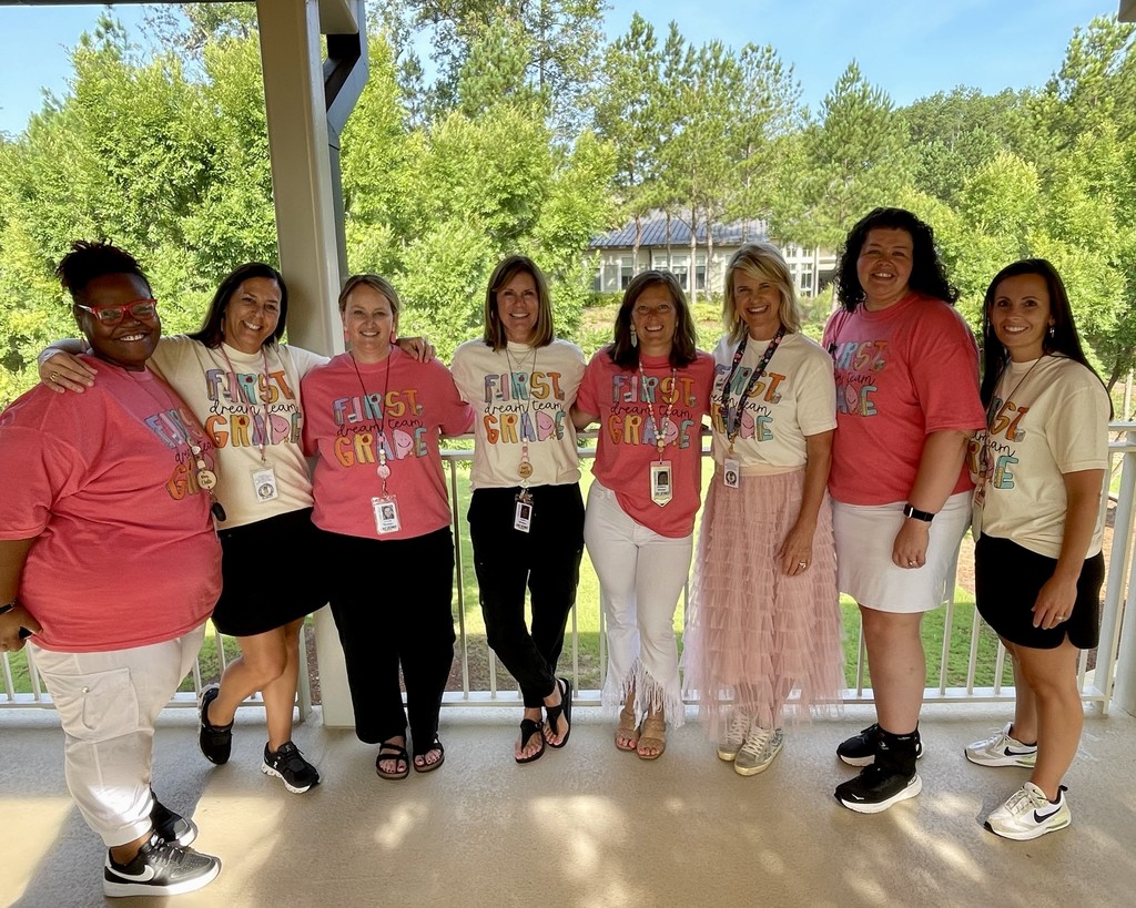 group of first grade teacher in matching shirts