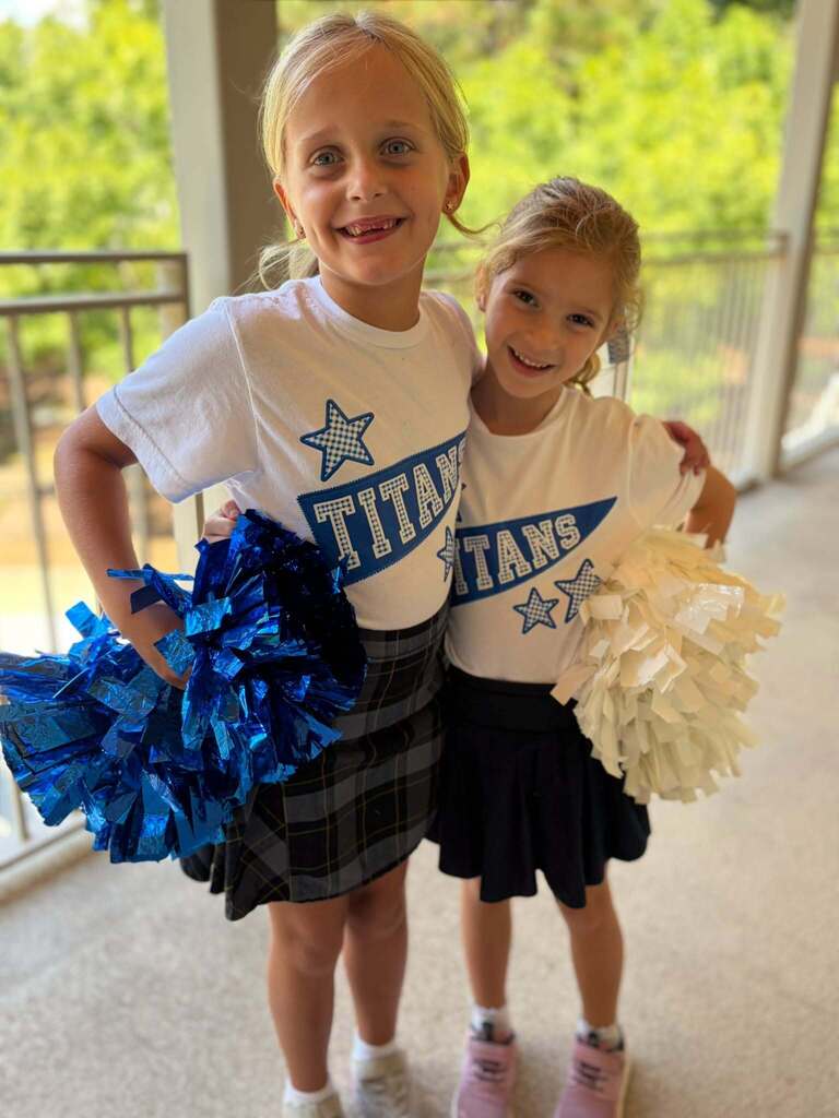 two students dress as cheerleaders