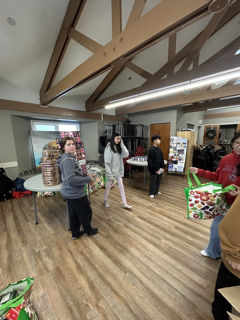 students sitting in front of food hampers