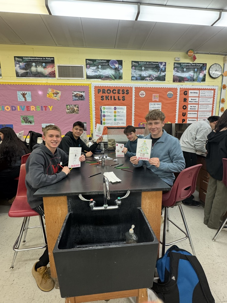 Service Club members showing off their holiday cards for hospitalized kids.