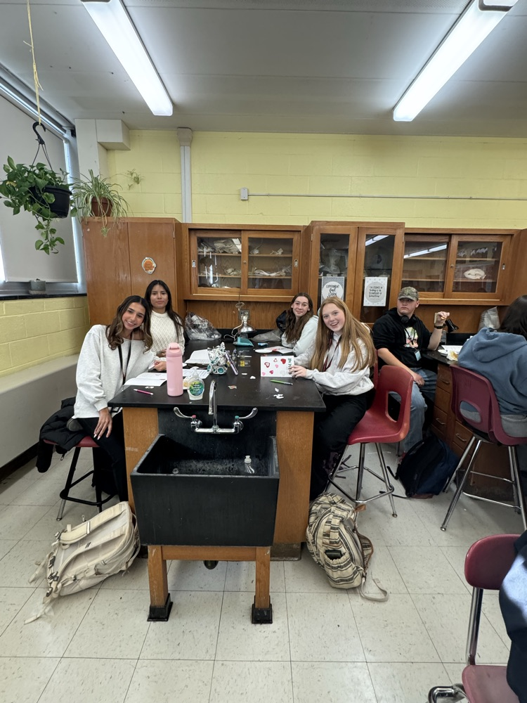 Service Club members showing off their holiday cards for hospitalized kids.