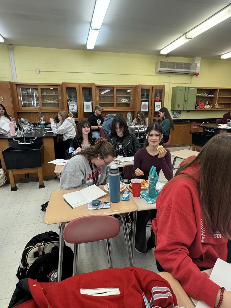 Service Club members showing off their holiday cards for hospitalized kids.