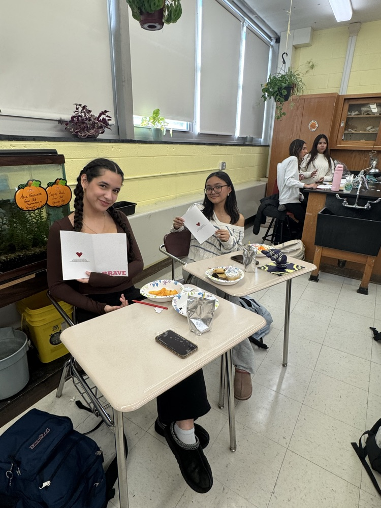 Service Club members showing off their holiday cards for hospitalized kids.