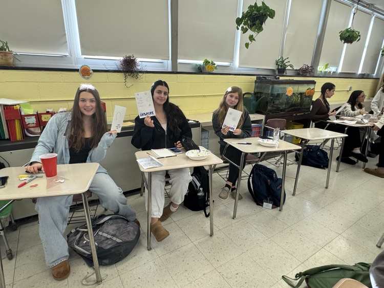 Service Club members showing off their holiday cards for hospitalized kids.