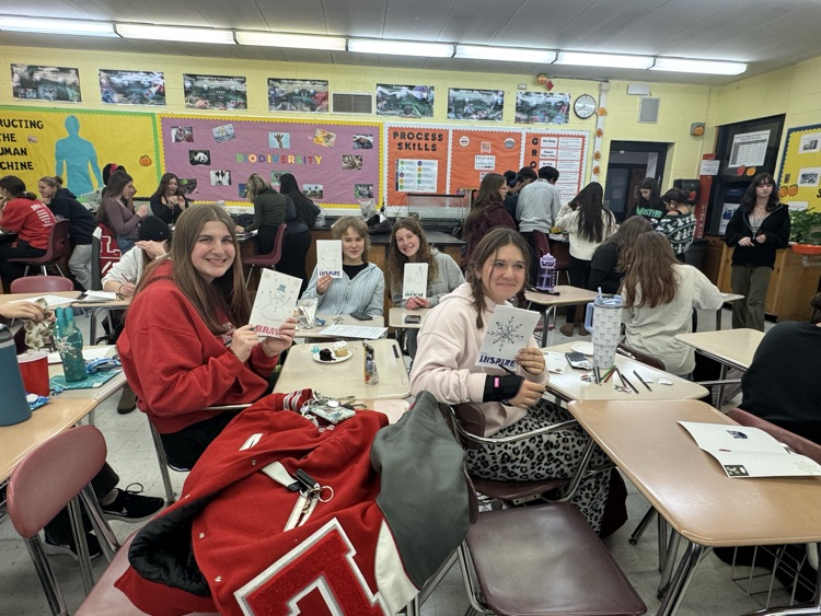 Service Club members showing off their holiday cards for hospitalized kids.