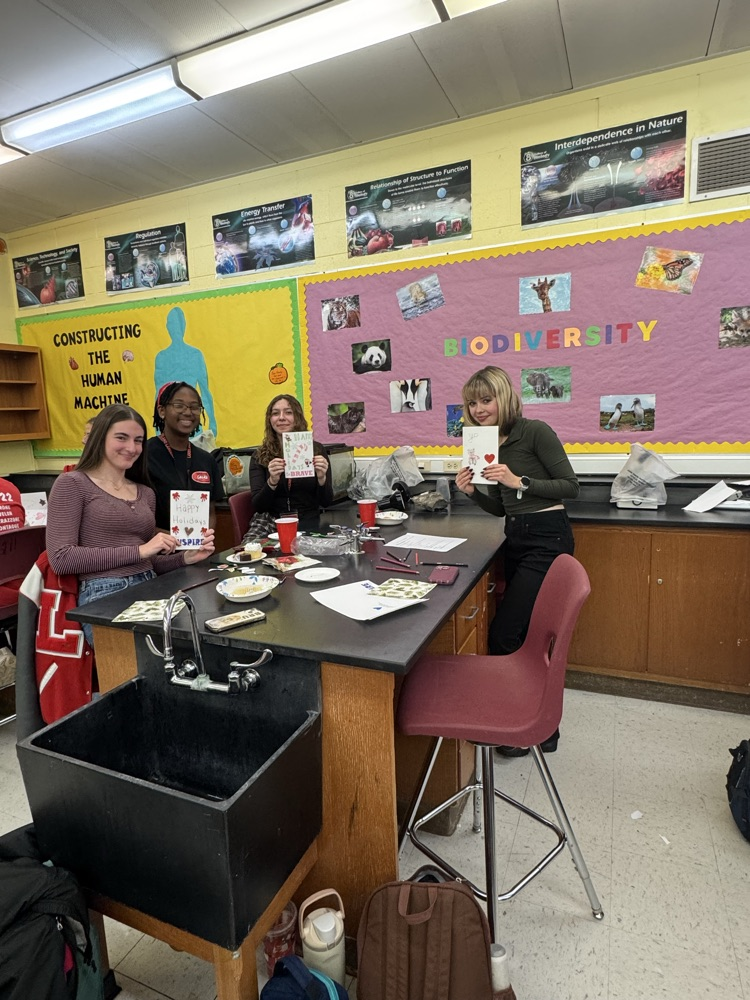 Service Club members showing off their holiday cards for hospitalized kids.