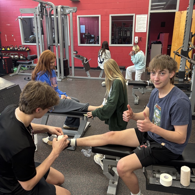 Mr. Cervino's Kinesiology class learning hands on taping methods from our Athletic Trainer Janell