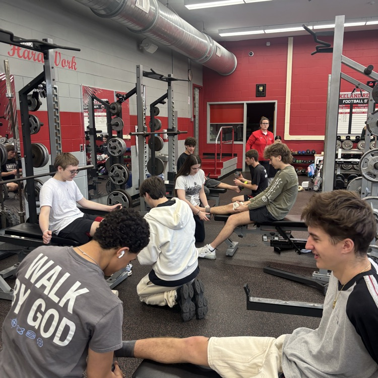 Mr. Cervino's Kinesiology class learning hands on taping methods from our Athletic Trainer Janell