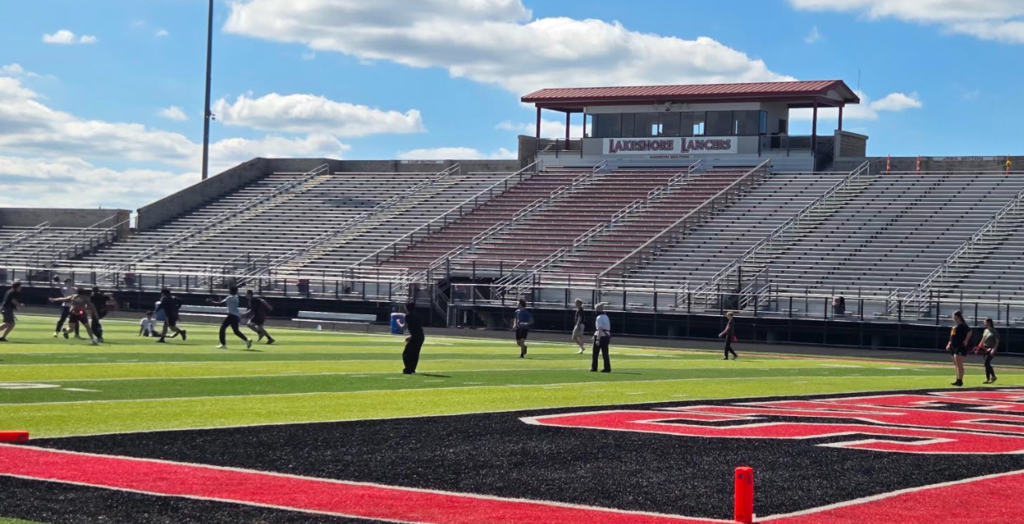 Football field w/ students playing flag football.