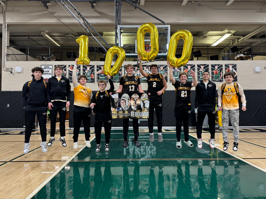Trey Johnson celebrating 1000 points and 1000 rebounds with his teammates