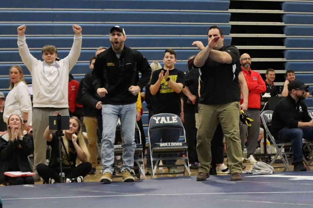 Coaches and spectators cheer for a LakeVille win!