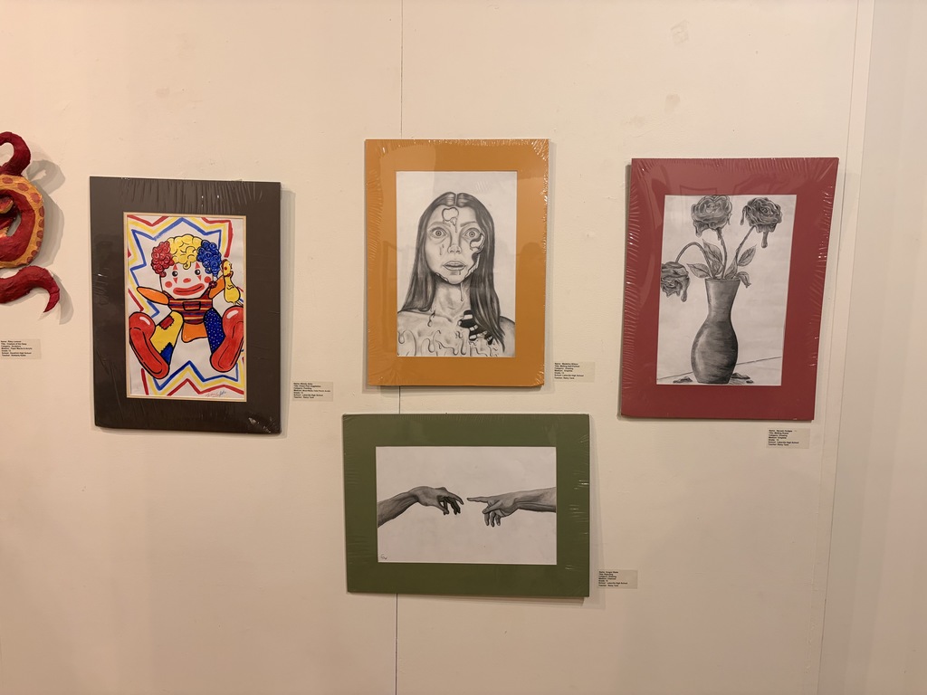 Student Artists who were able to make it to the show opening pictured with their work, Mariyah McNeil, Maddie Wilson, and Samantha Compton.