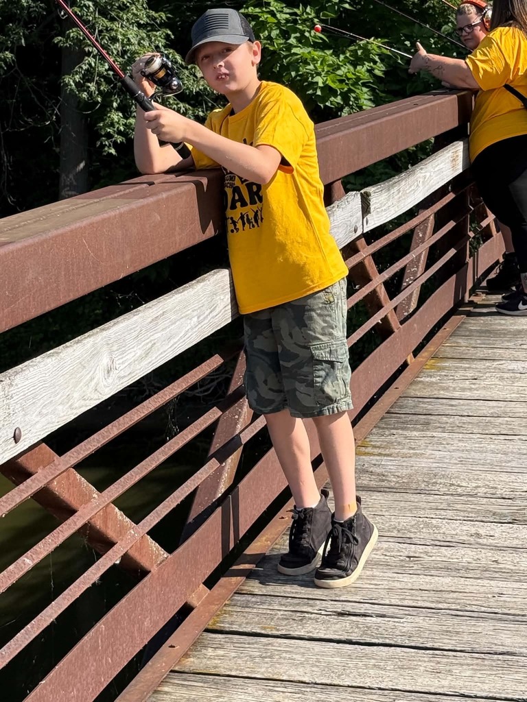 Photo of boy fishing on a bridge