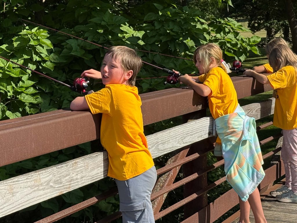 Photo of kids fishing on a bridge