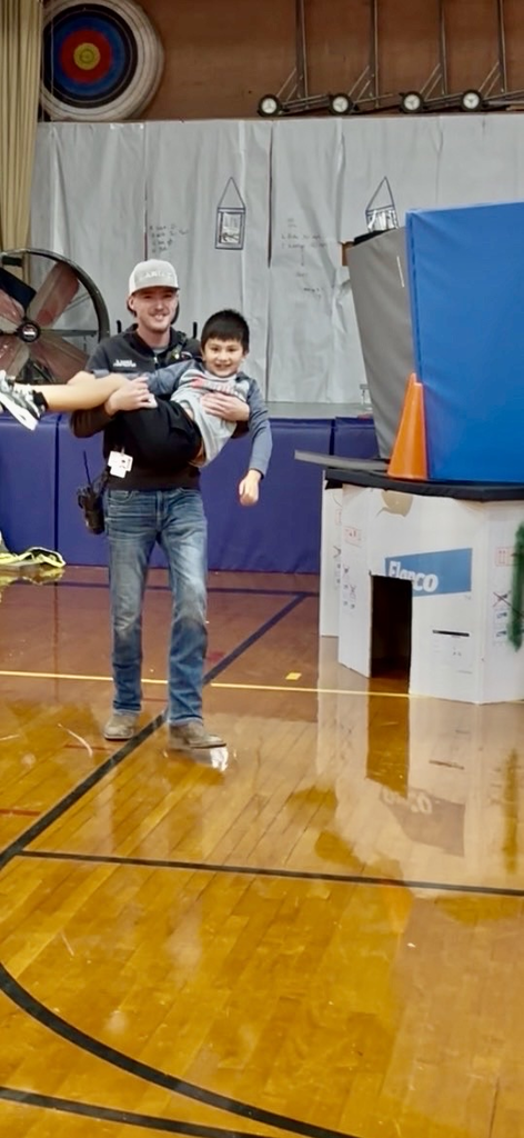 Fireman Evan Perez saving a student from his " house fire"