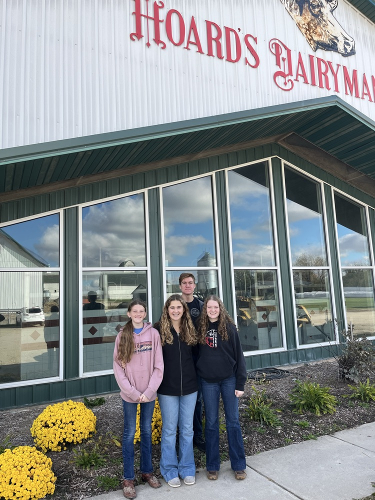 group in front of barn
