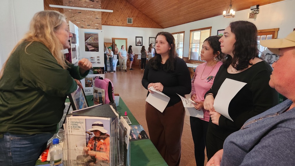 Students at the Marine and Career Fair listening to someone talking about their career