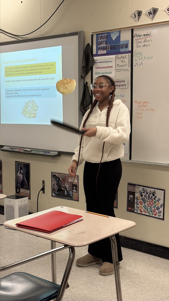 Student flipping a crepe in French class
