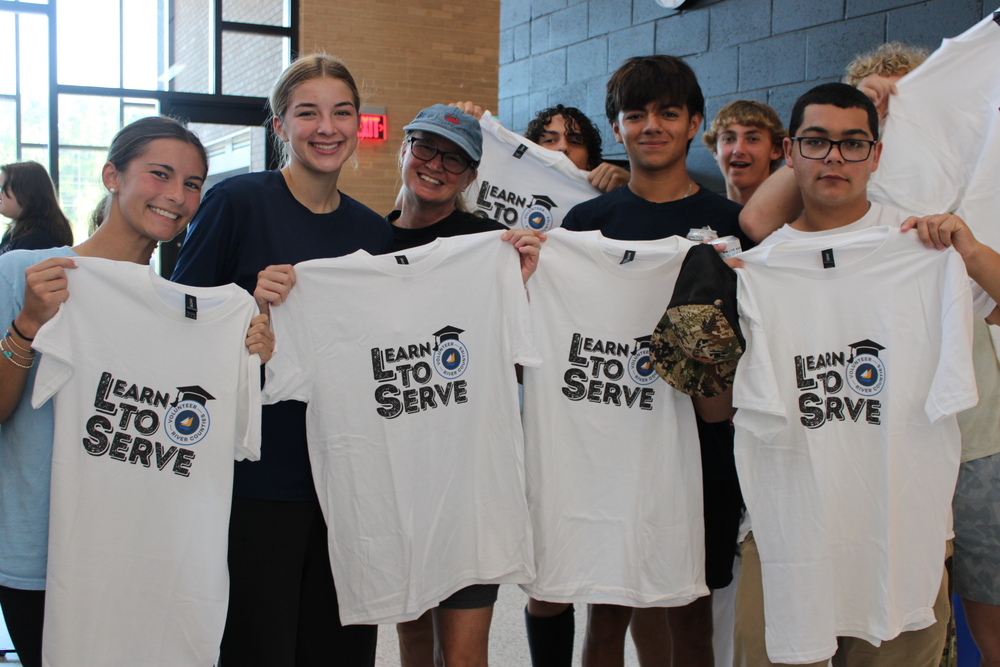 Students with Learn to Serve Shirts getting ready to go out into the community and do community service.