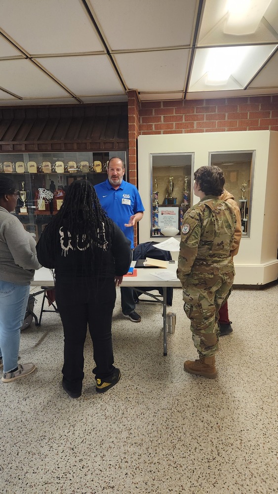 Students talking to the Blue Heron Battery member, Kevin Voleman