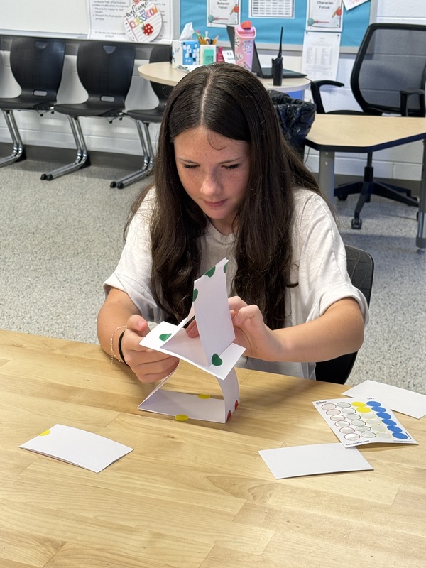 6th grade students making an index card tower