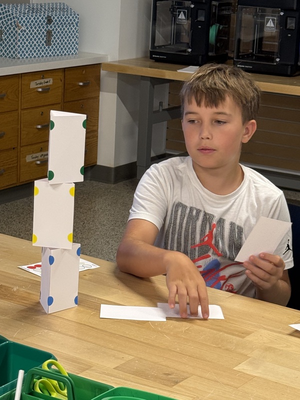 6th grade students making an index card tower