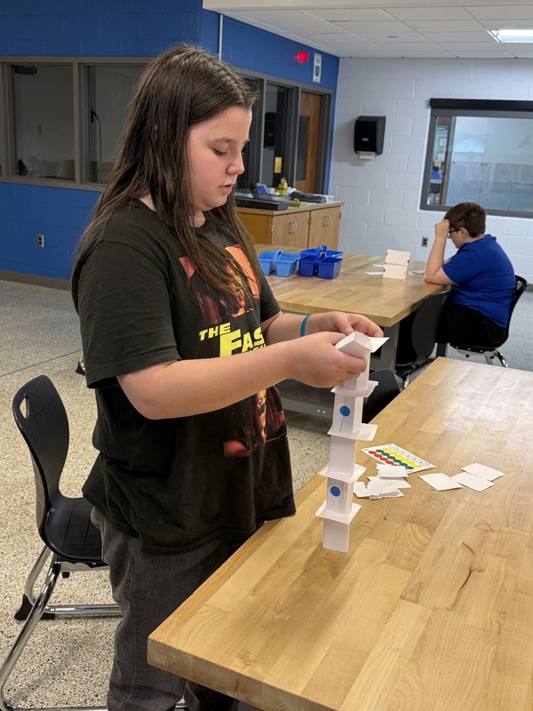 6th grade students making an index card tower