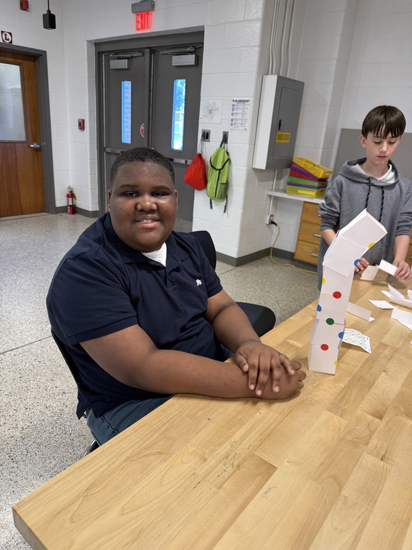 6th grade students making an index card tower
