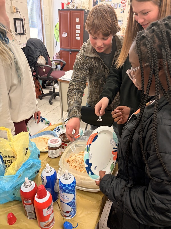 Mrs. Anderson's French class students trying crepes