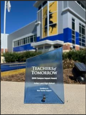 award in front of school building